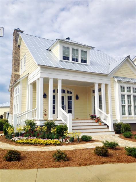 yellow house with white metal roof|yellow house with gray roof.